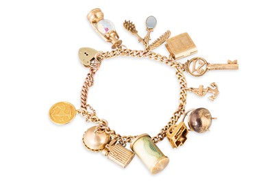 Lot 294 - A 9CT YELLOW GOLD CHARM BRACELET, with various...
