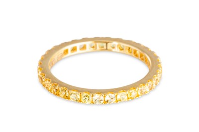 Lot 66 - A YELLOW SAPPHIRE FULL BANDED ETERNITY RING,...