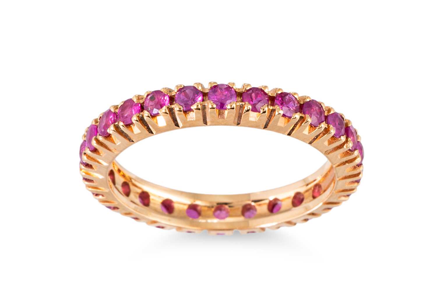 Lot 67 - A RUBY FULL BANDED ETERNITY RING, mounted in...