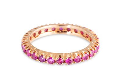Lot 67 - A RUBY FULL BANDED ETERNITY RING, mounted in...
