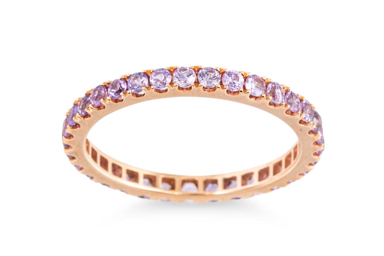 Lot 68 - A PURPLE SAPPHIRE FULL BANDED ETERNITY RING,...