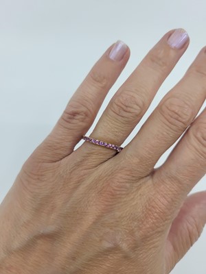 Lot 68 - A PURPLE SAPPHIRE FULL BANDED ETERNITY RING,...