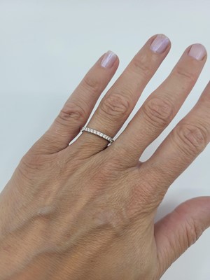 Lot 138 - A DIAMOND HALF ETERNITY RING, mounted in...