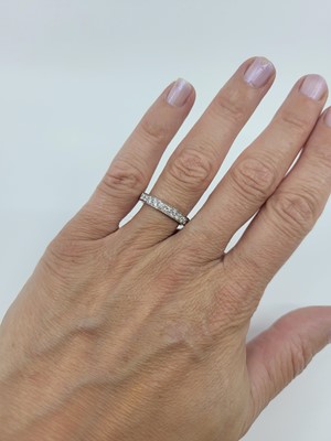 Lot 183 - A DIAMOND HALF ETERNITY RING, the brilliant...
