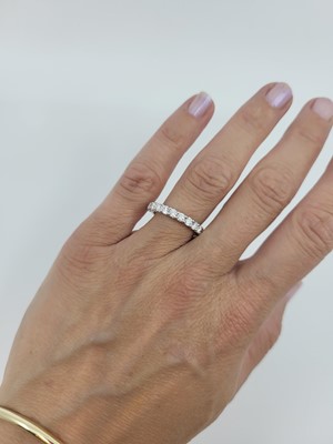 Lot 186 - A DIAMOND HALF ETERNITY RING, the brilliant...