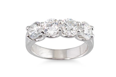 Lot 282 - A DIAMOND FOUR STONE RING, the brilliant cut...