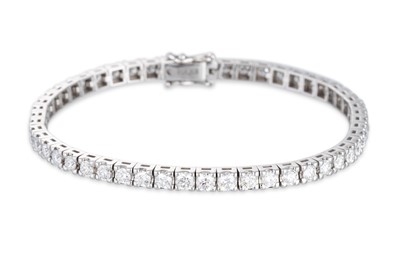 Lot 284 - A DIAMOND LINE BRACELET, the brilliant cut...
