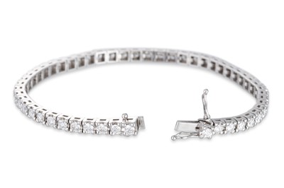 Lot 284 - A DIAMOND LINE BRACELET, the brilliant cut...