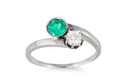 Lot 205 - AN EMERALD AND DIAMOND 'TOI ET MOI' RING, set...