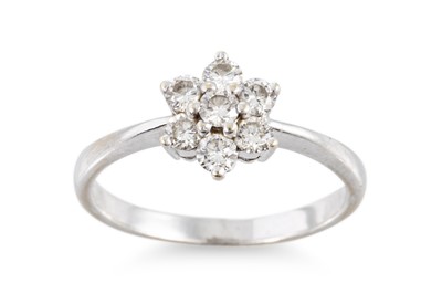 Lot 265 - A DIAMOND SEVEN STONE CLUSTER RING, mounted in...