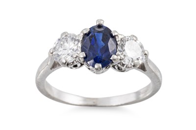 Lot 427 - A SAPPHIRE AND DIAMOND THREE STONE RING, the...