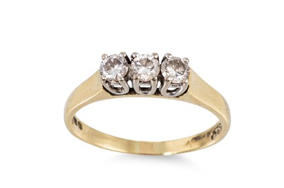 Lot 54 - A THREE STONE DIAMOND RING, the brilliant cut...