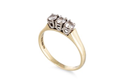 Lot 54 - A THREE STONE DIAMOND RING, the brilliant cut...