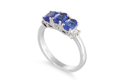 Lot 67 - A THREE STONE TANZANITE RING, the three oval...