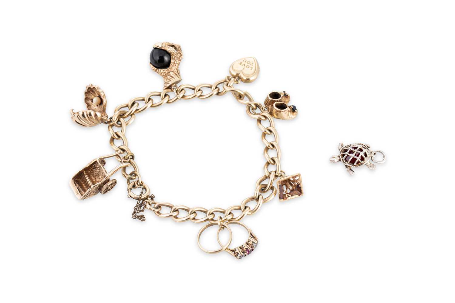 Lot 49 - A 9CT YELLOW GOLD CHARM BRACELET, set with...