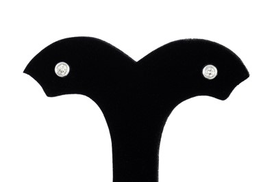 Lot 23 - A PAIR OF DIAMOND STUD EARRINGS, the bezel set...