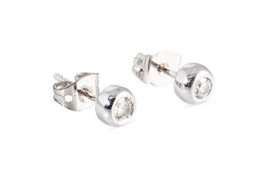 Lot 23 - A PAIR OF DIAMOND STUD EARRINGS, the bezel set...