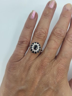 Lot 38 - A SAPPHIRE AND STONESET CLUSTER RING, mounted...
