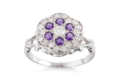 Lot 39 - A DIAMOND AND AMETHYST DAISY STYLE CLUSTER...