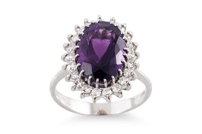 Lot 128 - AN AMETHYST AND DIAMOND CLUSTER RING, the oval...