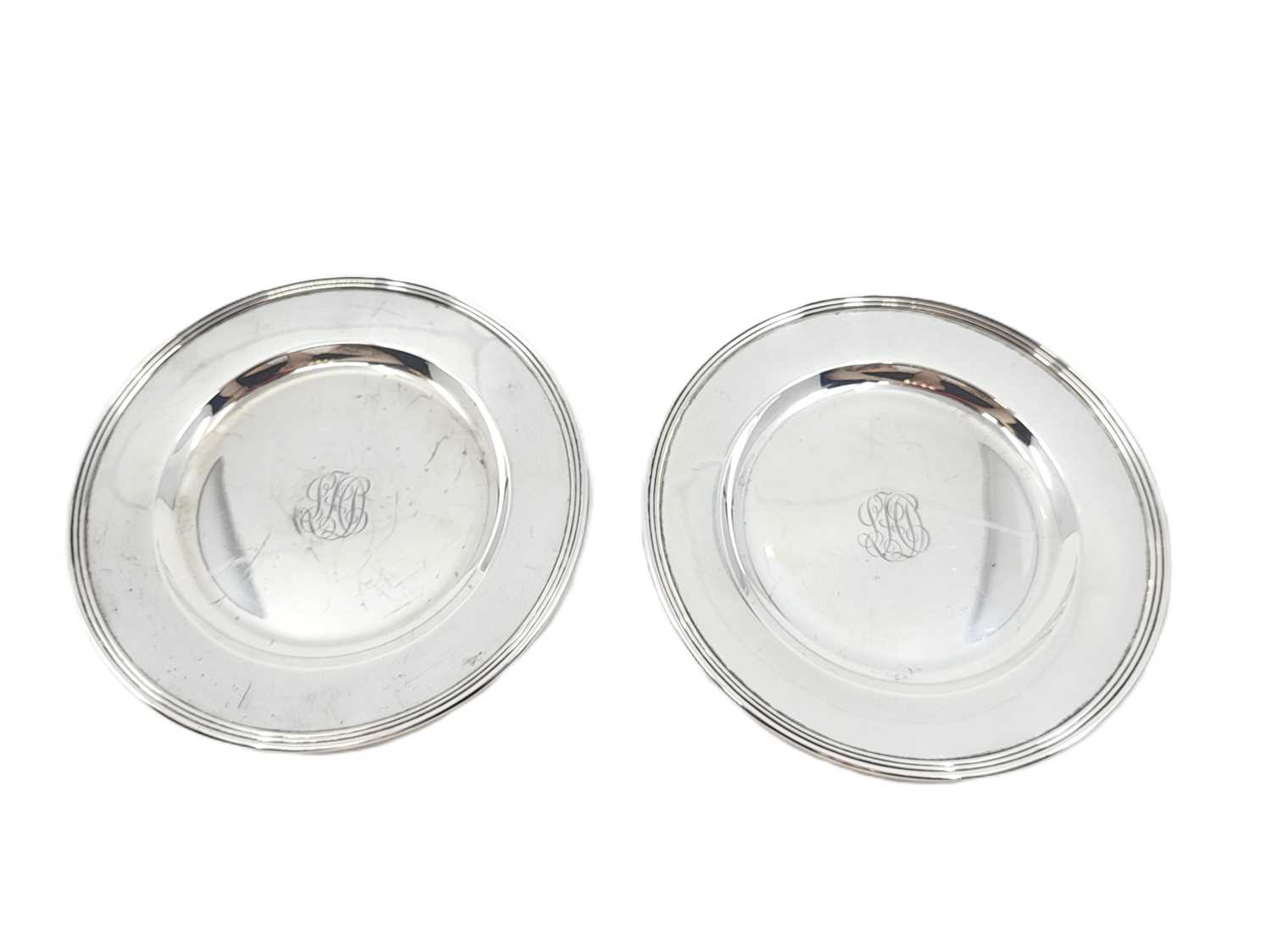 Lot 545 - A PAIR OF MID-20TH-CENTURY USA CIRCULAR SILVER...