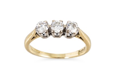 Lot 179 - A THREE STONE DIAMOND RING, the round...