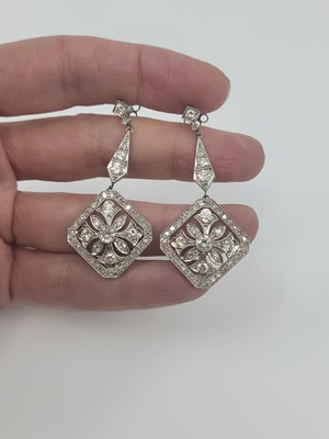 Lot 83 - A PAIR OF DIAMOND DROP EARRINGS, the round...