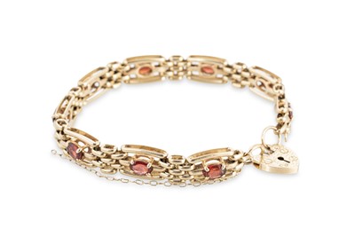 Lot 318 - A 9CT YELLOW GOLD GARNET SET GATE BRACELET,...