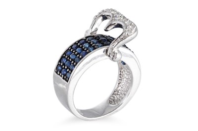 Lot 87 - A SAPPHIRE AND DIAMOND BUCKLE STYLE RING, the...