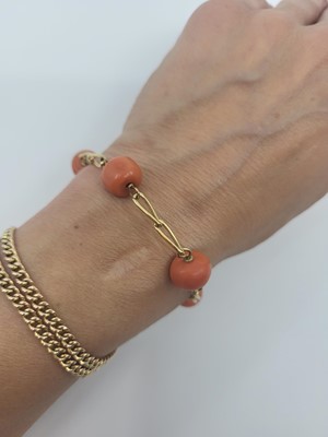 Lot 65 - A BEADED CORAL AND YELLOW GOLD BRACELET, the...