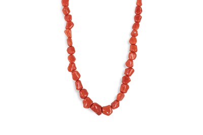 Lot 169 - A CORAL BEADED NECKLACE, to an 18ct gold ball...