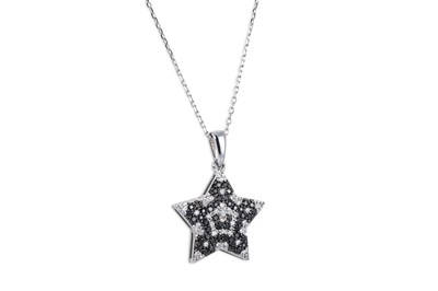 Lot 203 - A BLACK AND WHITE DIAMOND PENDANT, star shaped,...