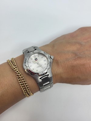 Lot 443 - A MIDSIZE TAG HEUER WRIST WATCH, silvered dial...