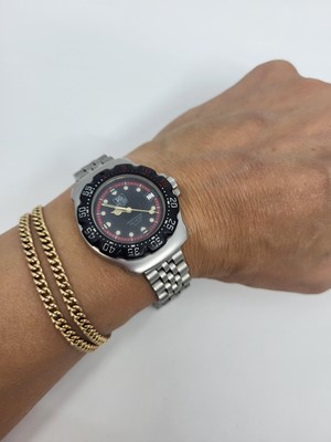 Lot 450 - A TAG HEUER WRIST WATCH, black dial with date,...