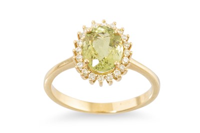 Lot 217 - A PERIDOT AND DIAMOND CLUSTER RING, the oval...