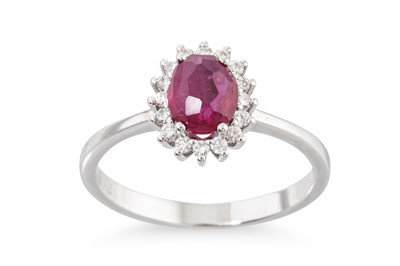 Lot 222 - A RUBY AND DIAMOND CLUSTER RING, the central...