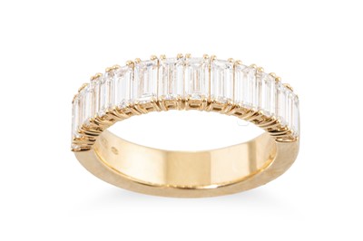 Lot 297 - AN EMERALD CUT DIAMOND HALF ETERNITY RING,...