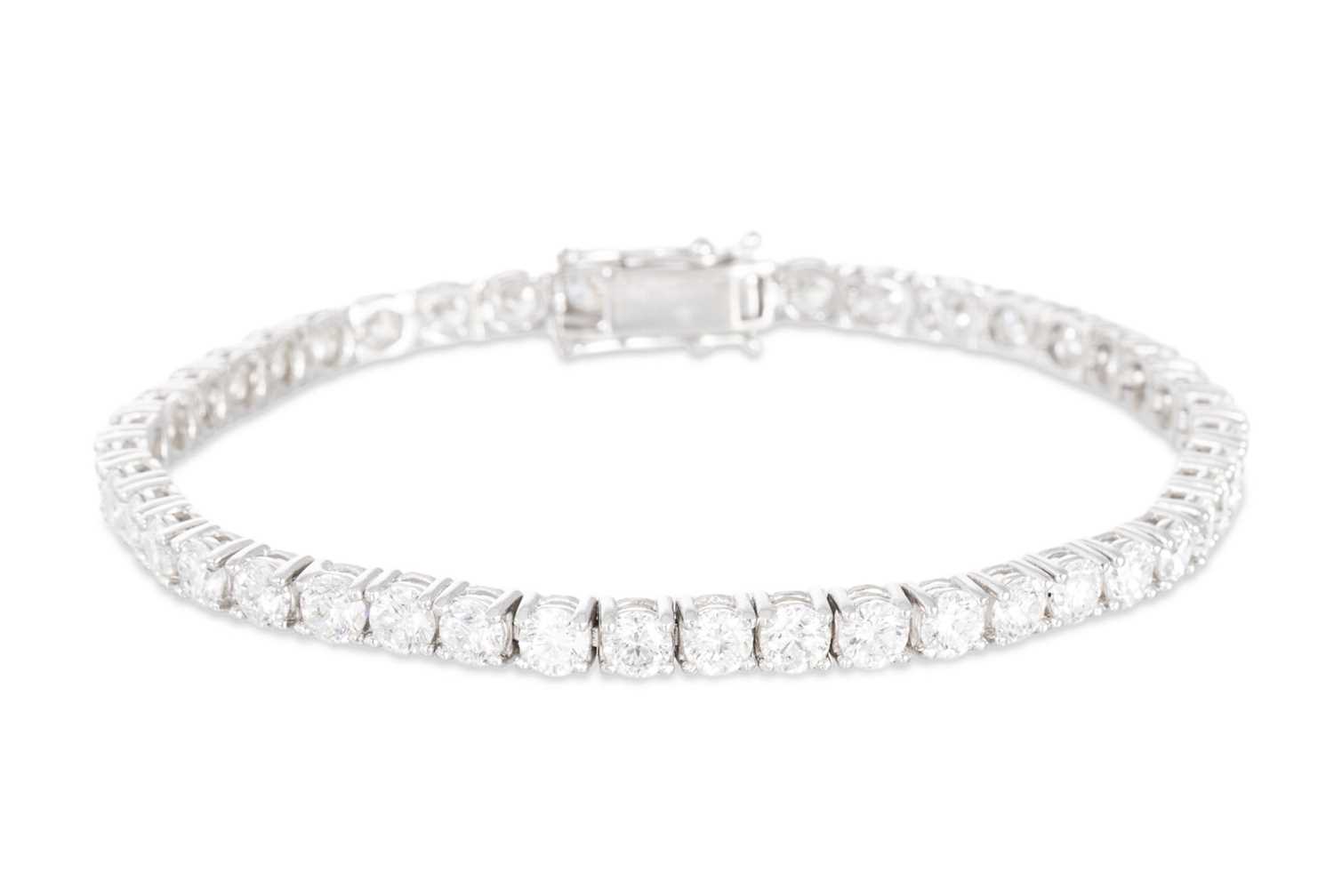 Lot 397 - A DIAMOND LINE BRACELET, the brilliant cut...