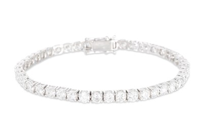 Lot 397 - A DIAMOND LINE BRACELET, the brilliant cut...