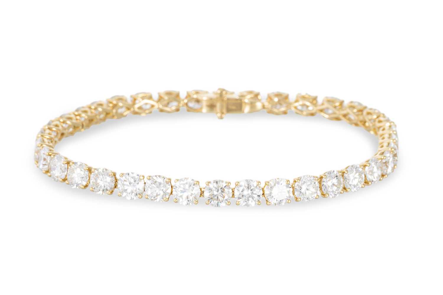 Lot 401 - A DIAMOND LINE BRACELET, the brilliant cut...