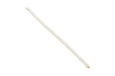 Lot 401 - A DIAMOND LINE BRACELET, the brilliant cut...