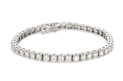 Lot 404 - A DIAMOND LINE BRACELET, the brilliant cut...