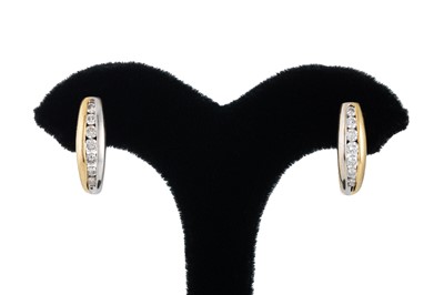 Lot 342 - A PAIR OF DIAMOND EARRINGS, channel set in...