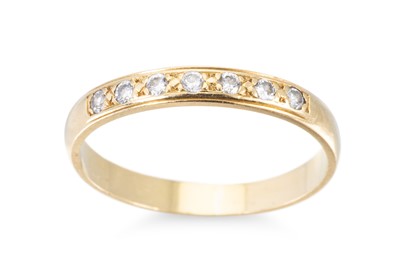 Lot 5 - A DIAMOND SEVEN STONE BAND RING, the round...