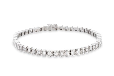 Lot 287 - A DIAMOND LINE BRACELET, set with emerald cut...