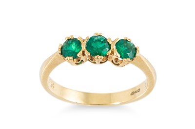 Lot 220 - A THREE STONE EMERALD RING, mounted in 18ct...