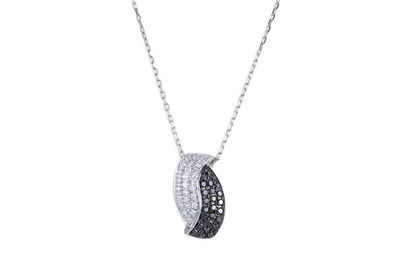 Lot 187 - A BLACK AND WHITE DIAMOND PAVÉ SET PENDANT,...