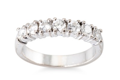 Lot 324 - A DIAMOND SEVEN STONE RING. The brilliant cut...
