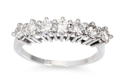 Lot 232 - A SEVEN STONE DIAMOND RING, the brilliant cut...