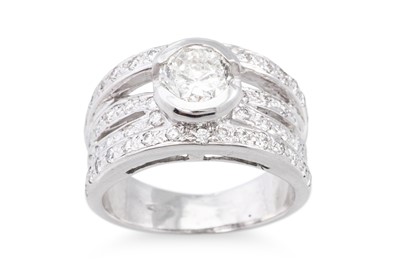 Lot 272 - A DIAMOND RING, the central bezel set...